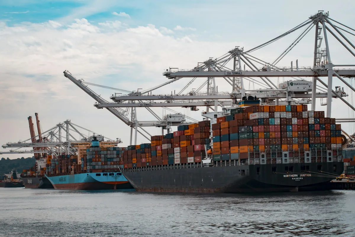 Container ships berthed under gantry cranes at a port terminal