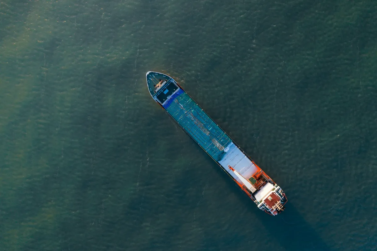 Aerial view of a cargo vessel on deep blue-green water