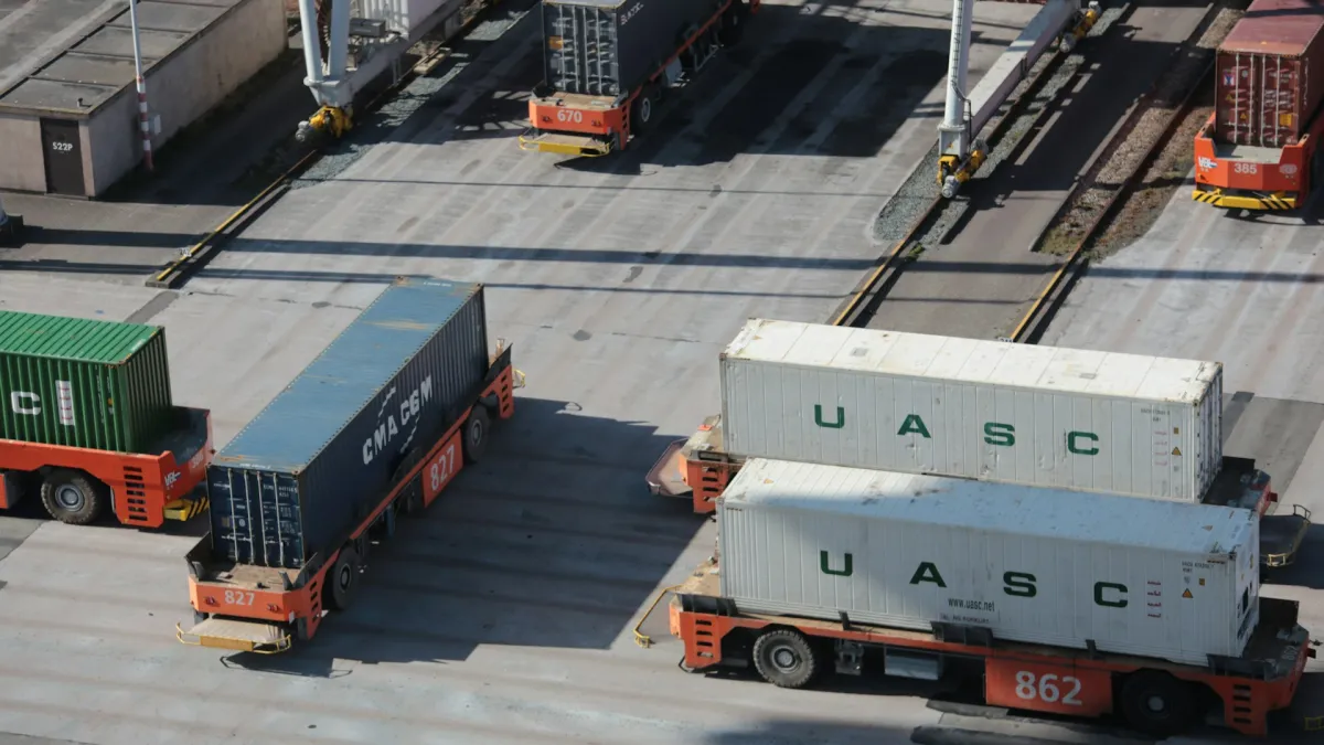 Open hold of a bulk carrier vessel receiving dry bulk commodities from harbor loading conveyors.