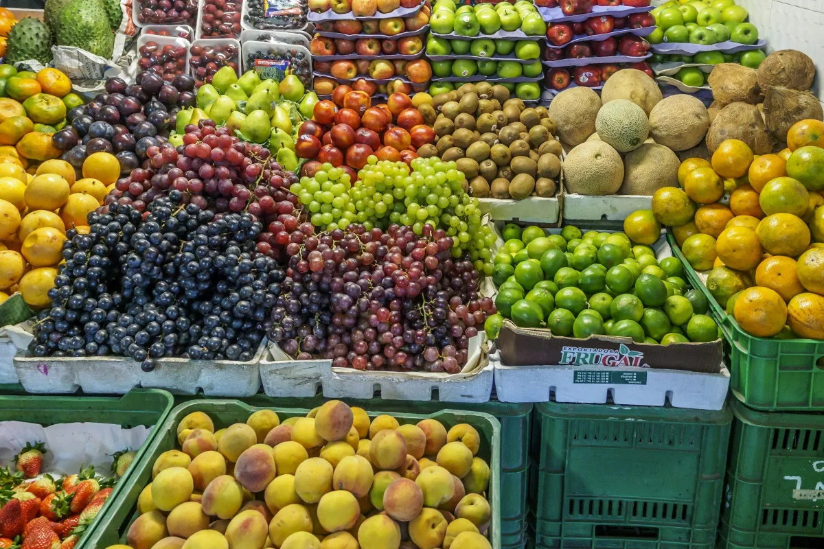 Market display of grapes, citrus, peaches and melons in crates